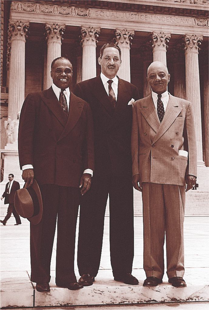 A photo: three men in suits stand in front of the U.S.
Supreme Court building.