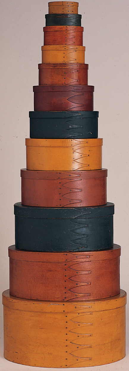 A dozen round boxes are piled
in a neat stack, with the largest on the bottom and the smallest on top.