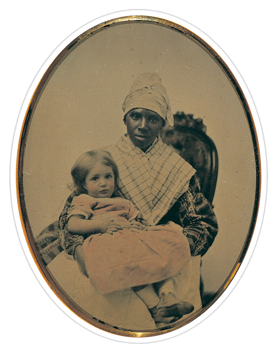 A photo shows an African-American woman holding a young
white girl on her lap.