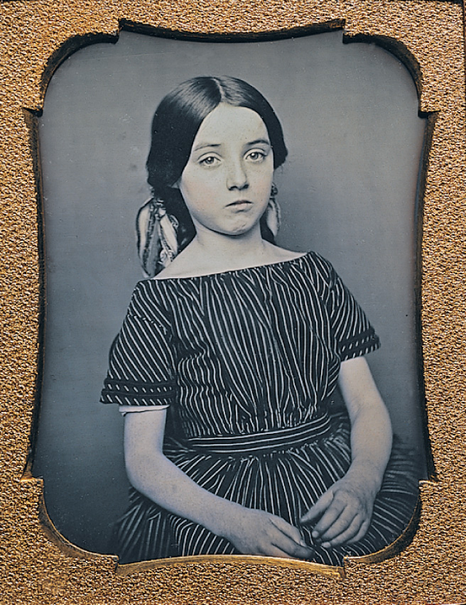 A black and white photo of a
young girl.