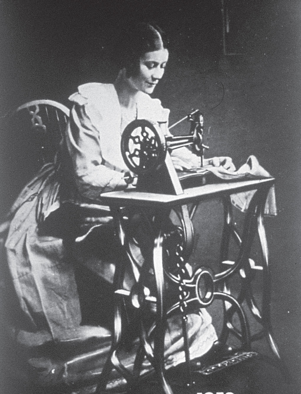 A woman runs a sewing
machine.