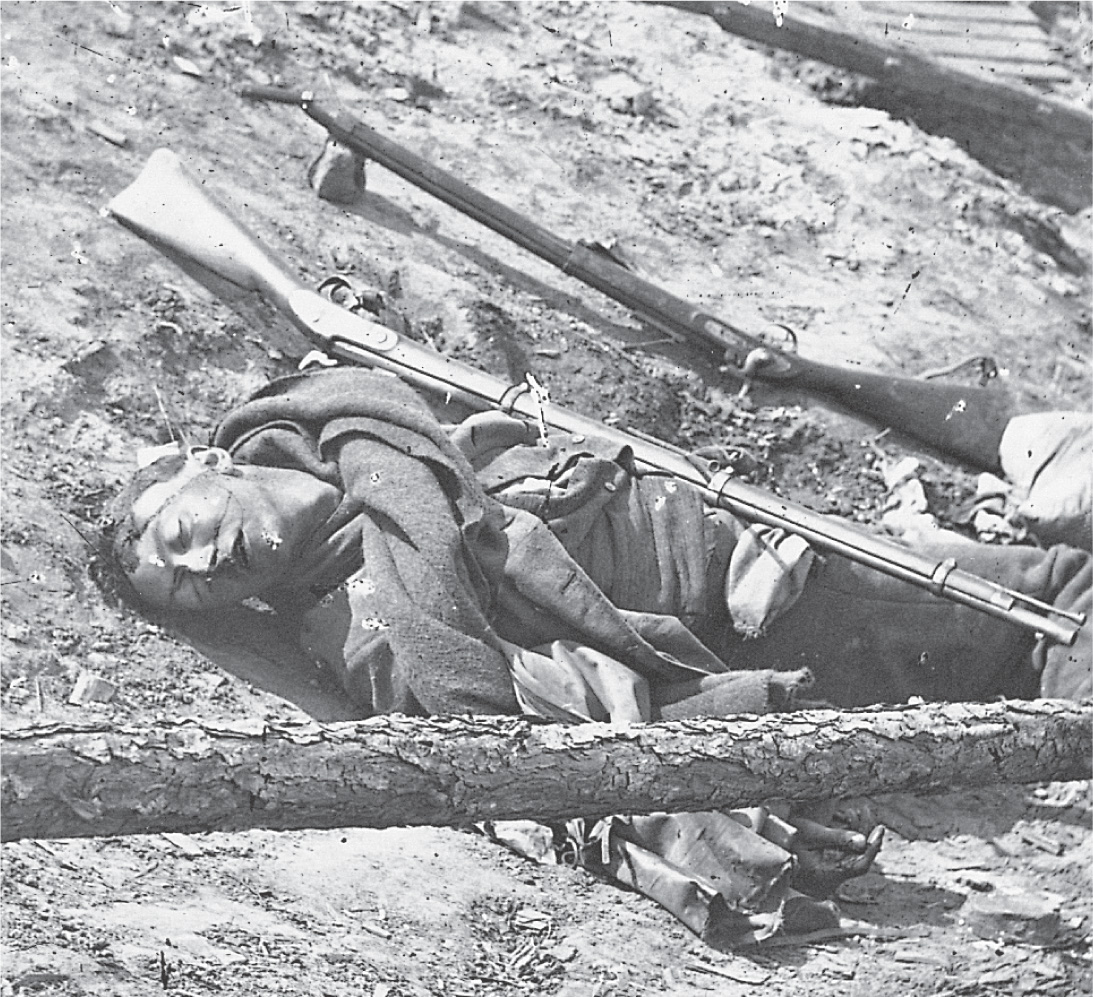 In a photo, a young soldier lies dead on a battlefield.