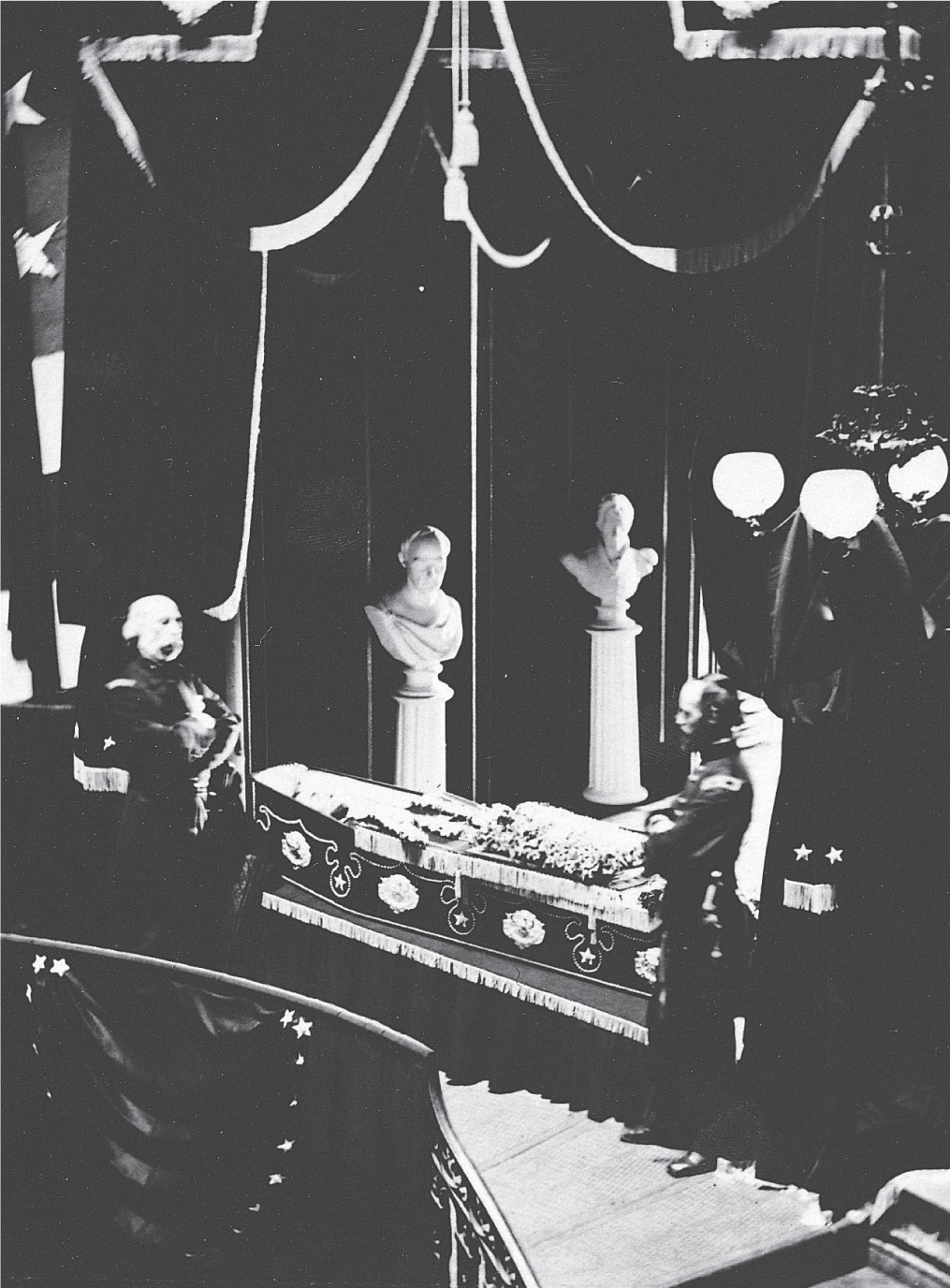 Uniformed soldiers stand by a casket.