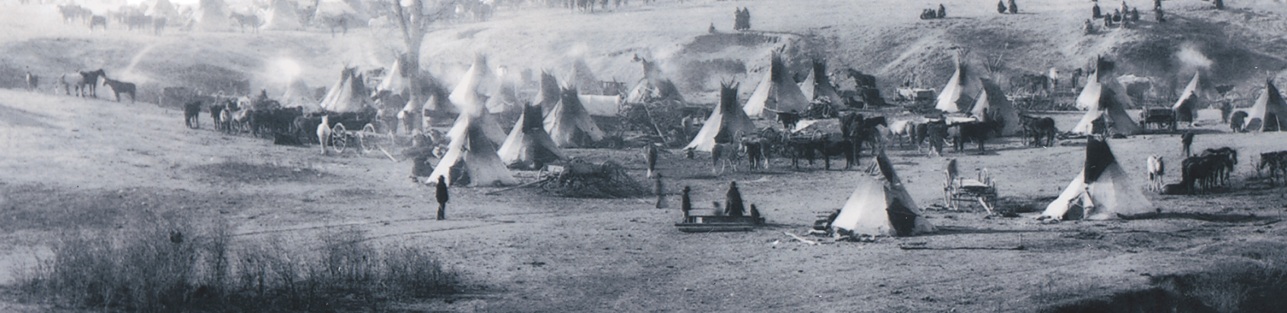 A photo shows a settlement of Native American tepees.