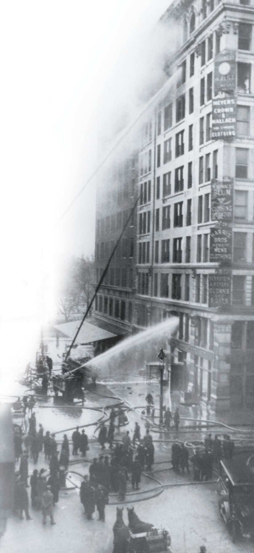 A photo: firemen spray water at a burning ten-story building.