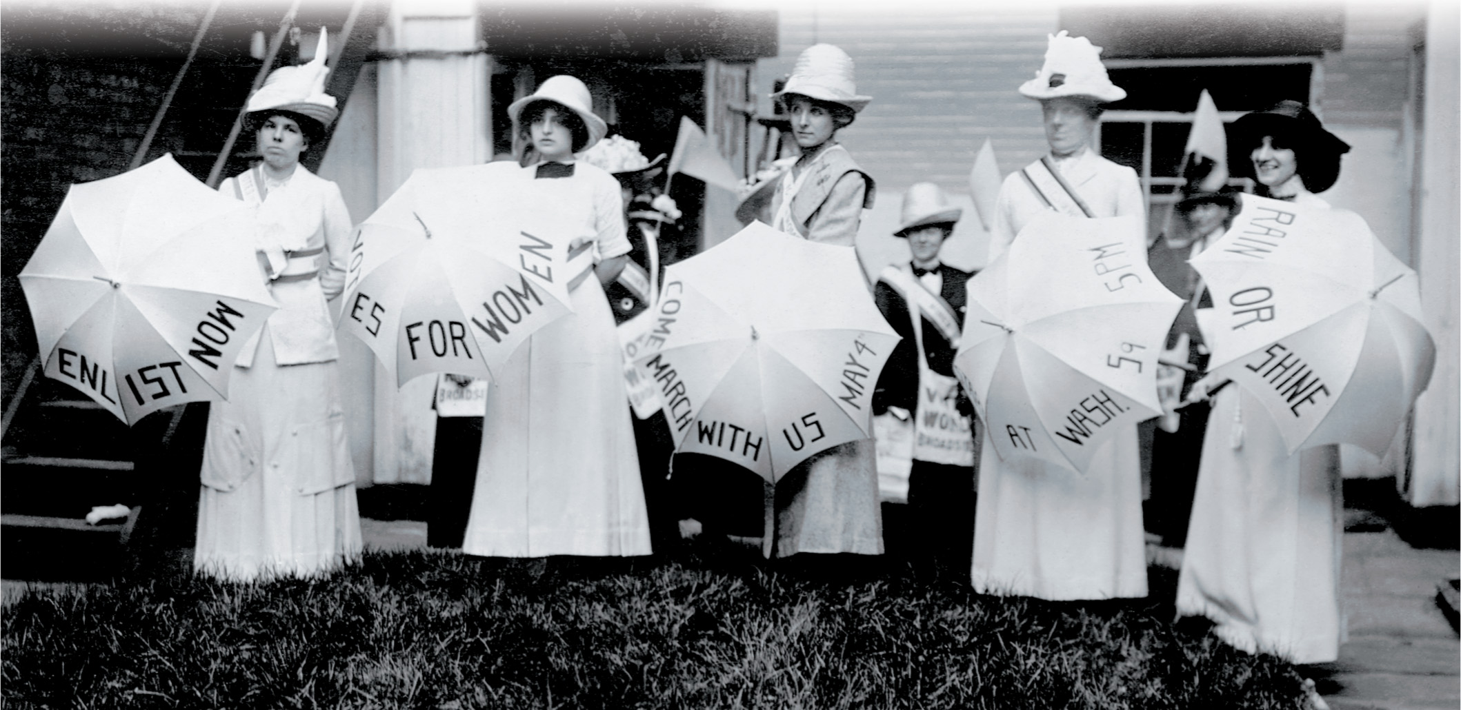 Words on suffragists' umbrellas spell out: Enlist Now. Votes for Women.  Come March with us May 4 at Washington Square, 5:00 p.m.  Rain or shine.