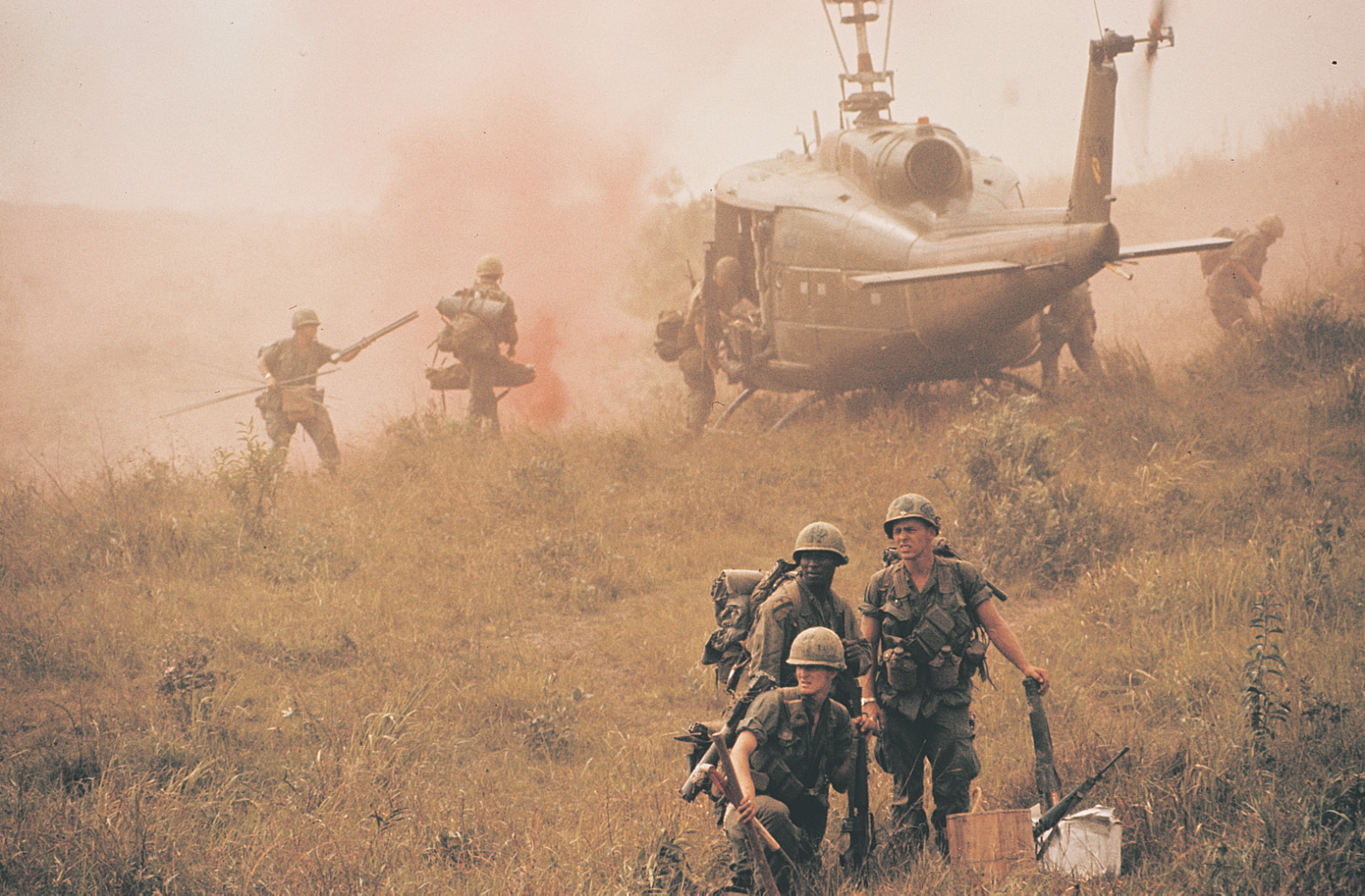 Photo: soldiers and helicopter in dusty field