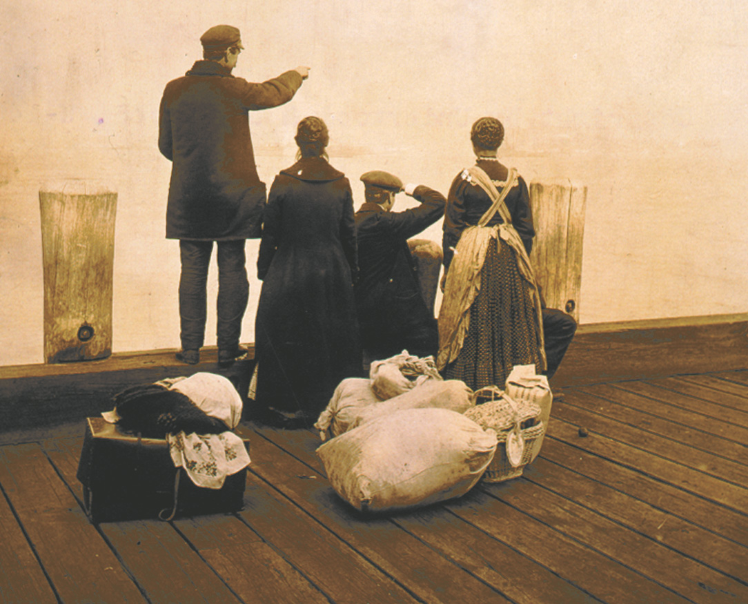 Photo: immigrants on a pier with sacks of belongings