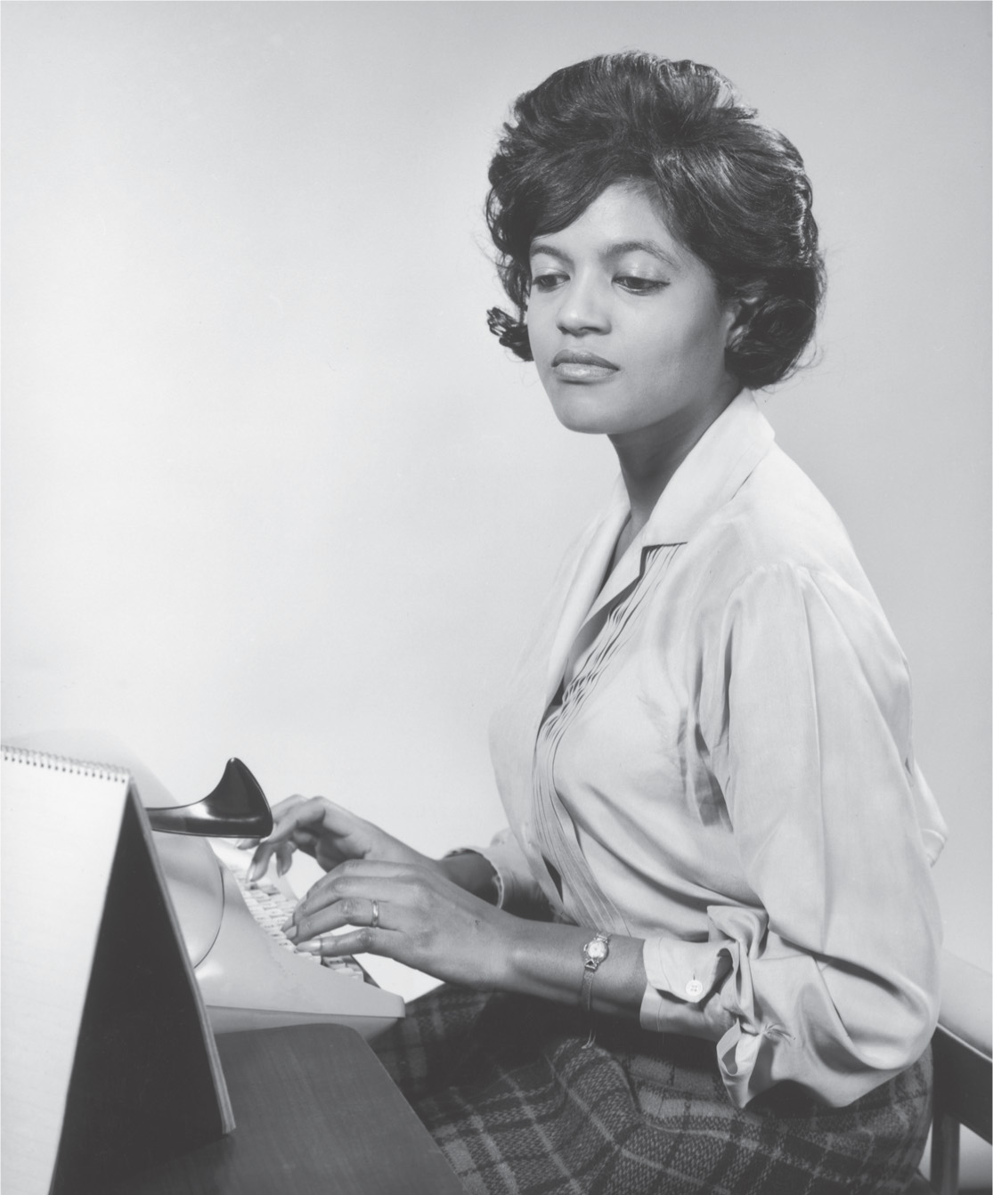 Photo: an African-American woman types on a keyboard