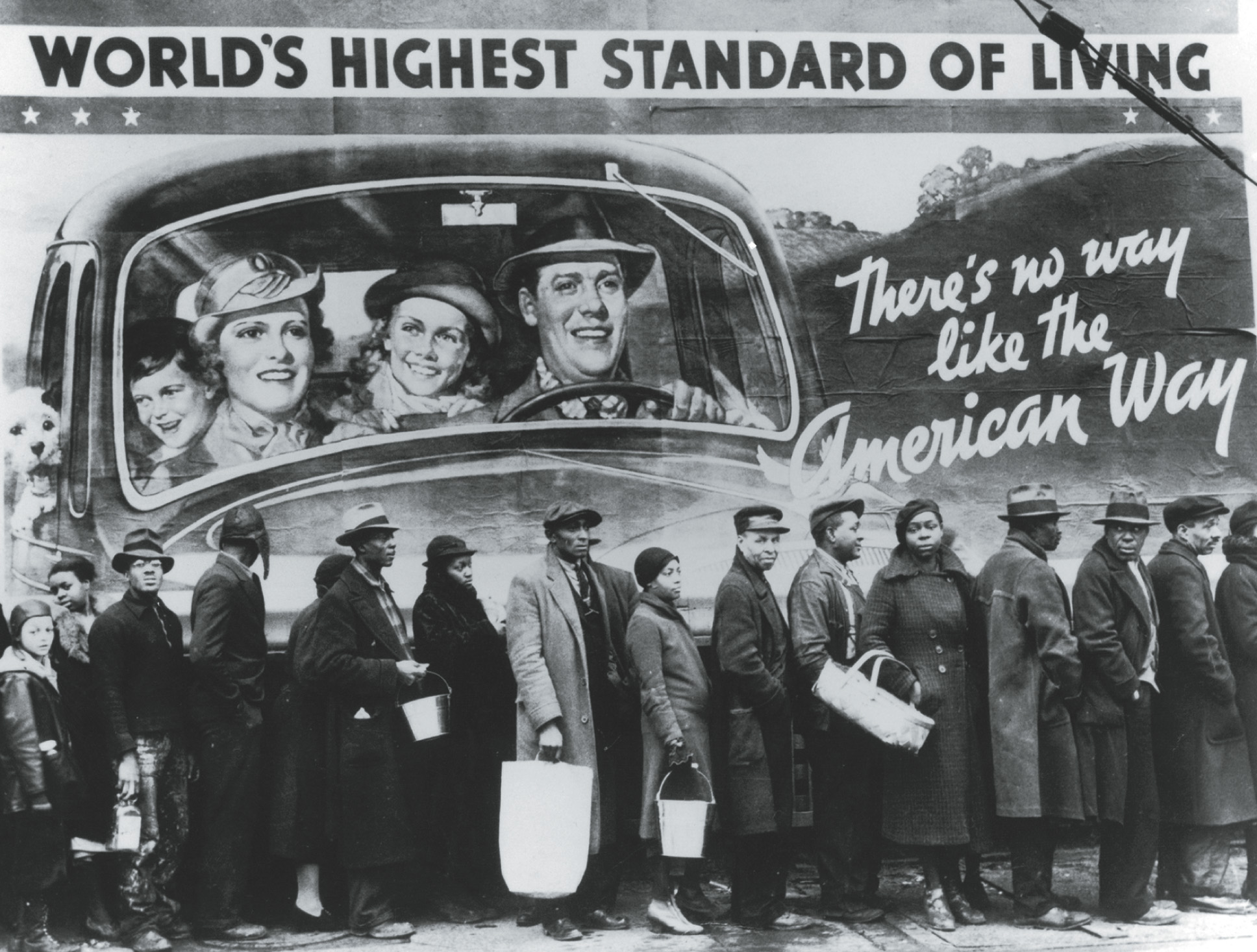Photo: people wait in a bread line in front of a billboard showing a happy family inside a car with the slogan there's no way like the American Way.