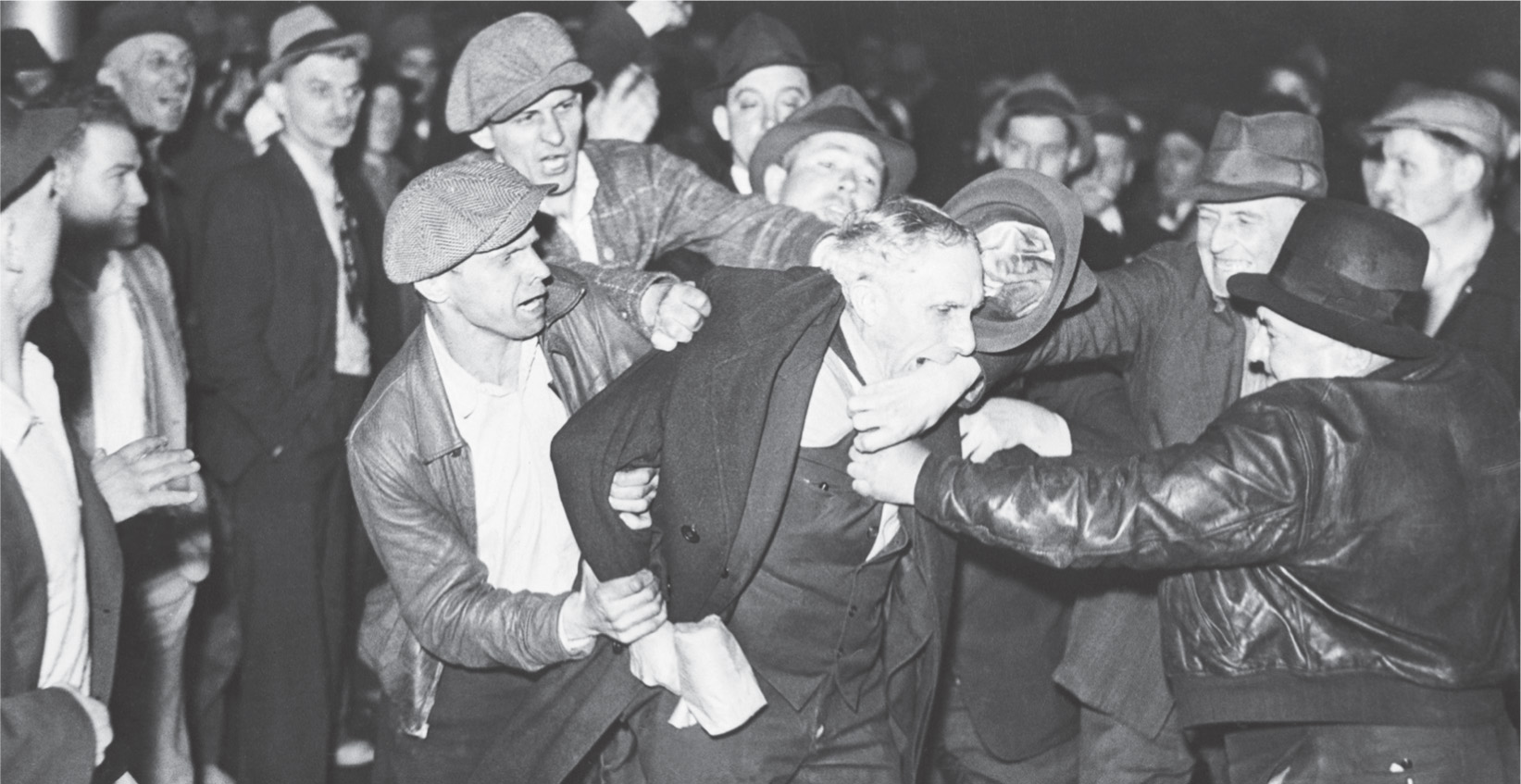 Photo: strikers prevent a man from crossing their picket line