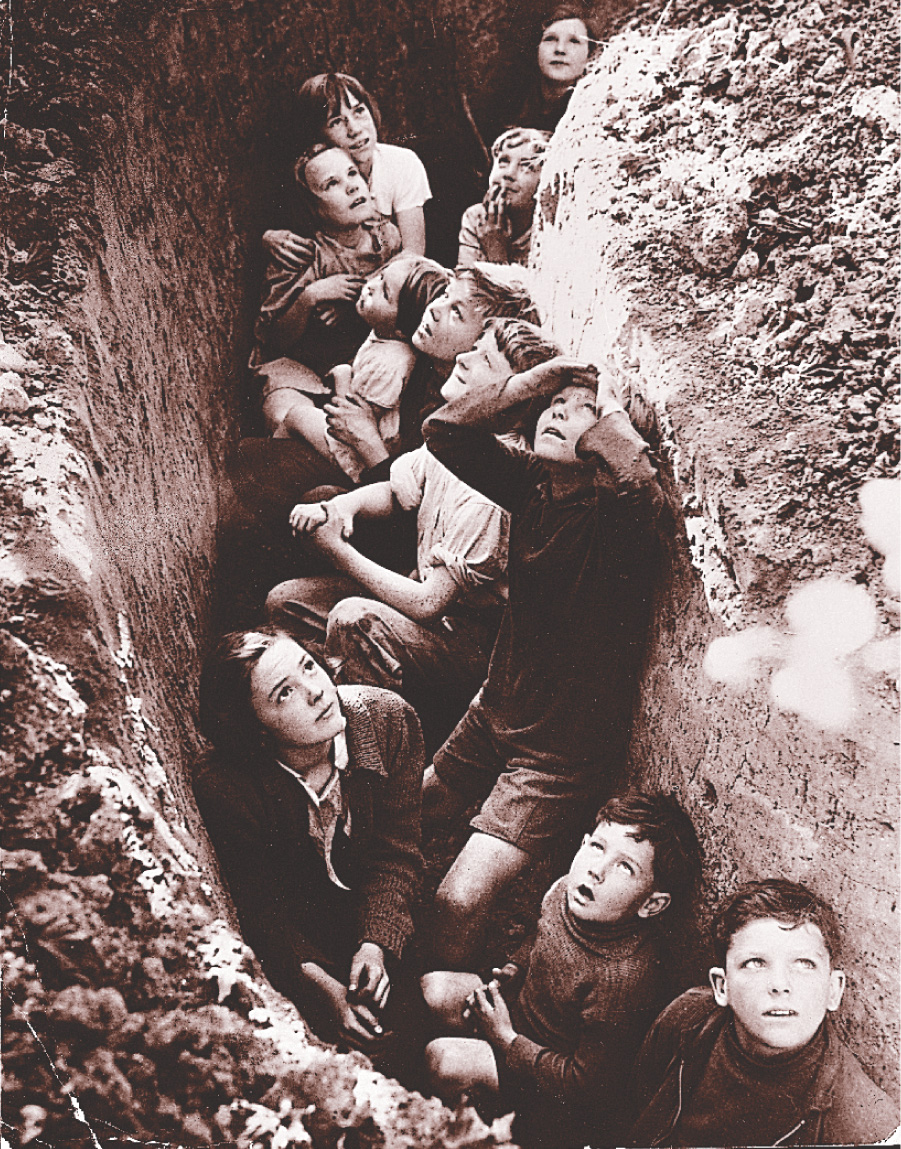 Photo: A dozen children cower in a trench