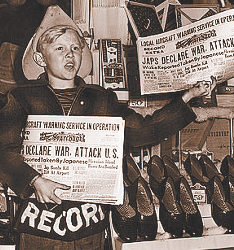 Photo: a boy sells newspapers with the headlines Japs Declare War. Attack U.S.