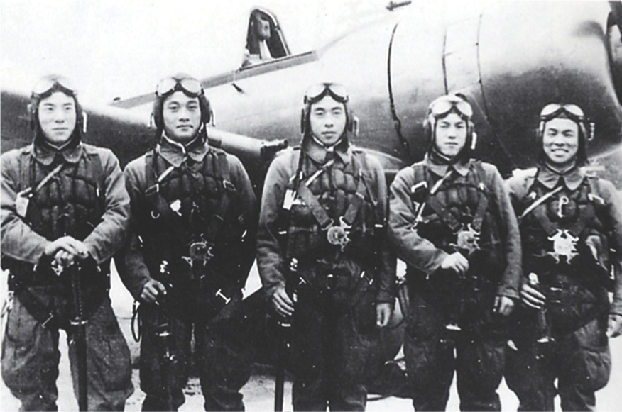 Photo: Young Japanese aviators stand in front of a plane