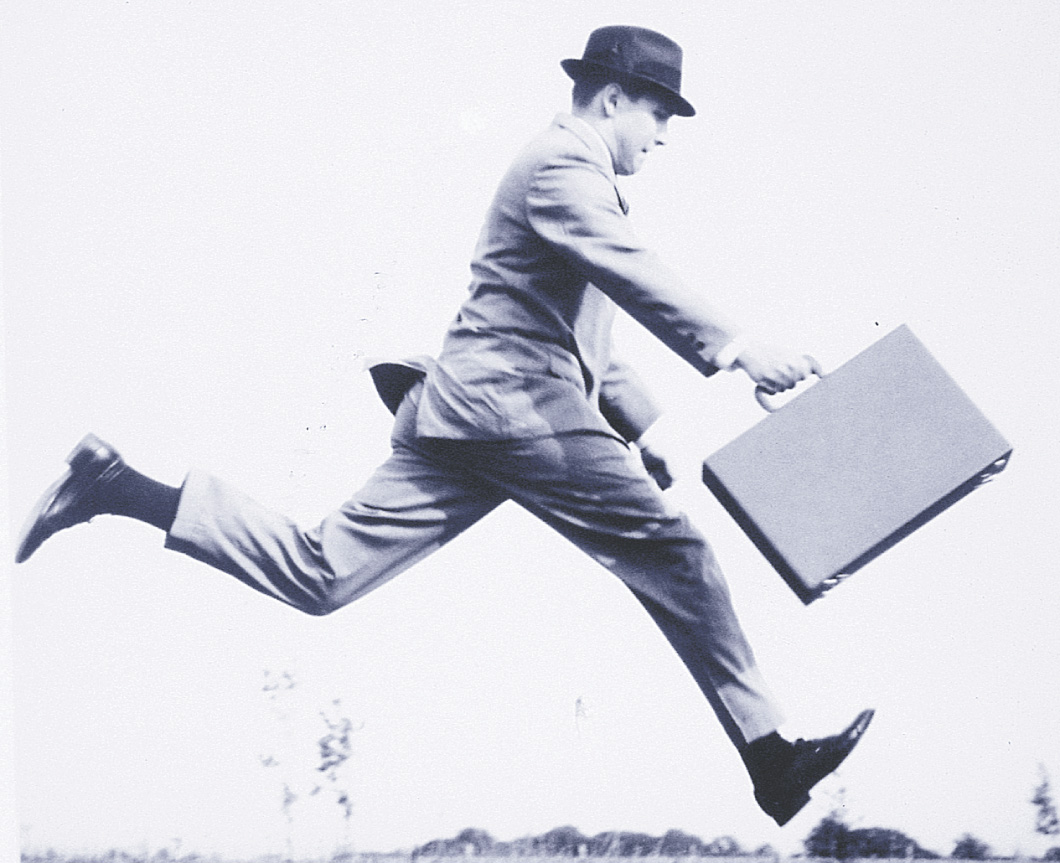 Photo: A businessman carrying a briefcase sprints