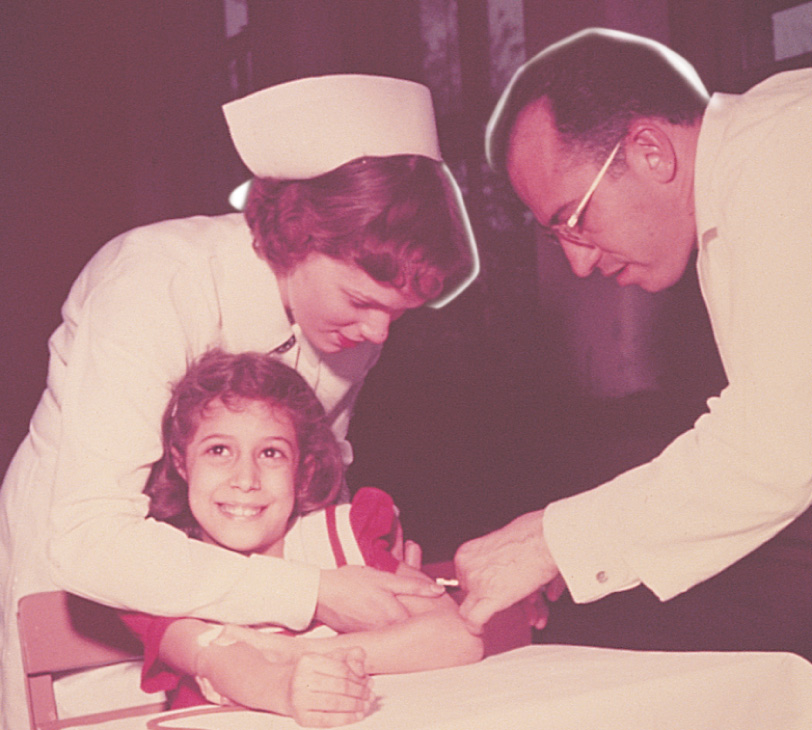 Photo: Jonas Salk injects vaccine into a girl's arm