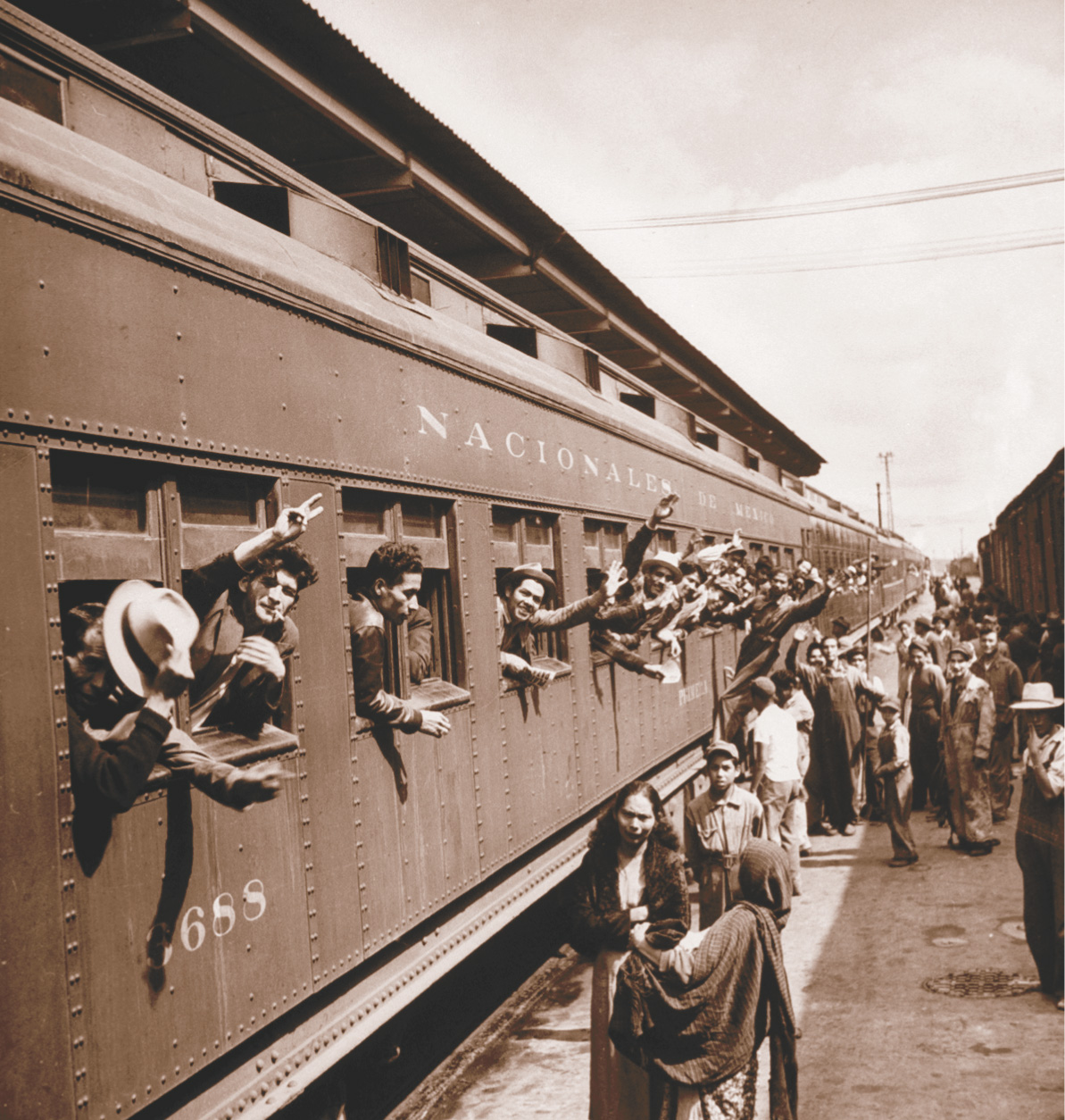 Photo: farmworkers wave from train windows