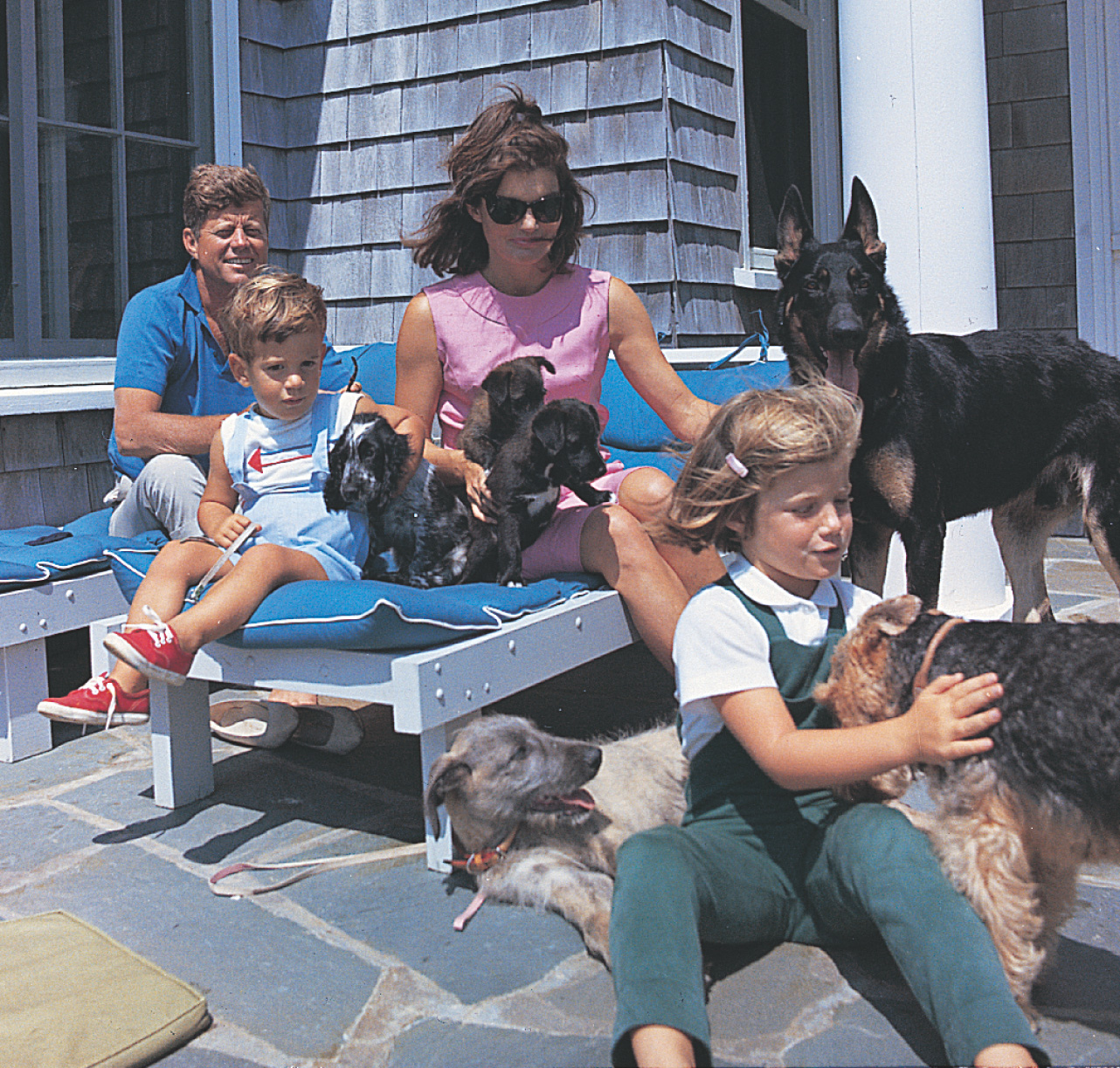 Photo: Kennedy and his wife
sit on deck chairs with their young son and daughter, petting a half-dozen dogs.