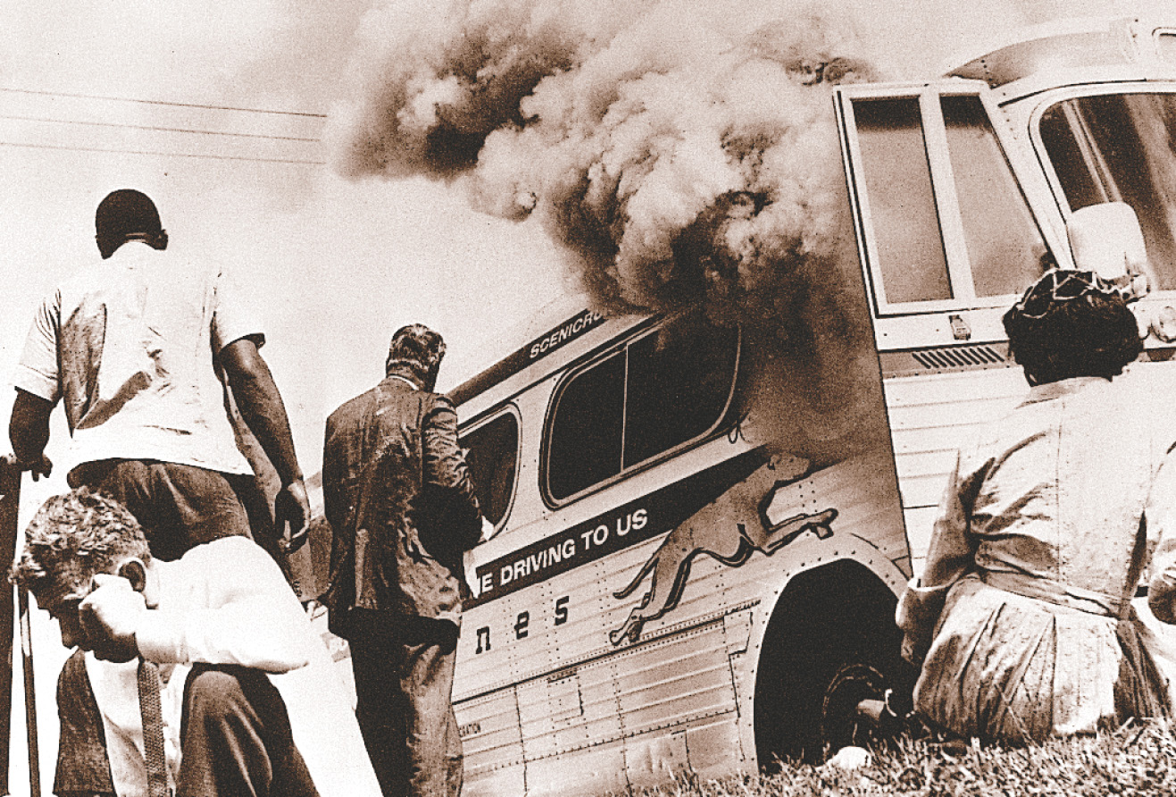 photo: African-Americans gather outside a burning bus.