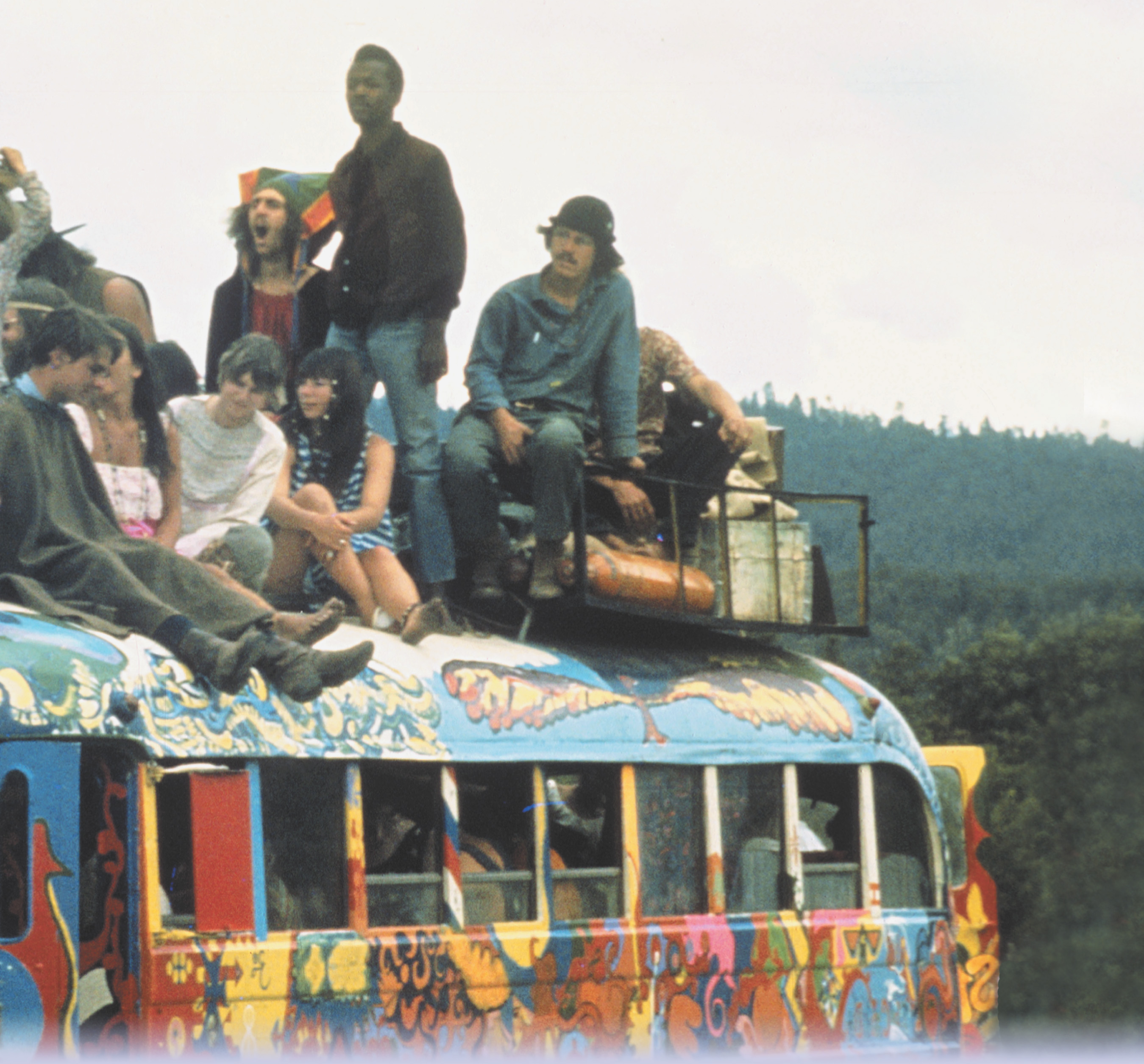 Photo: young people with long hair and colorful clothes sit atop a bus painted in wild colors. A title: An Era of Social Change.