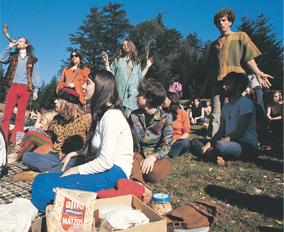 photo: young people with long hair gather in a park.