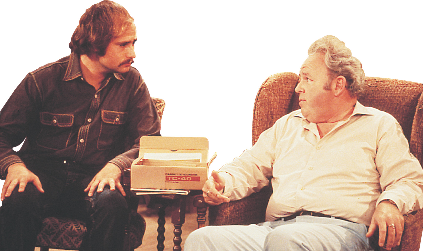 photo: in the T show All in the Fmaily, Archie Bunker sits with his son-in-law Mike.