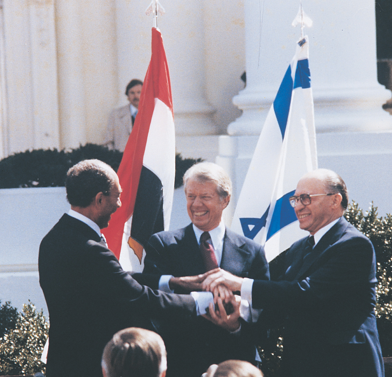 photo: Jimmy Carter, Menachem Begin and Anwar el-Sadat smile and join hands.