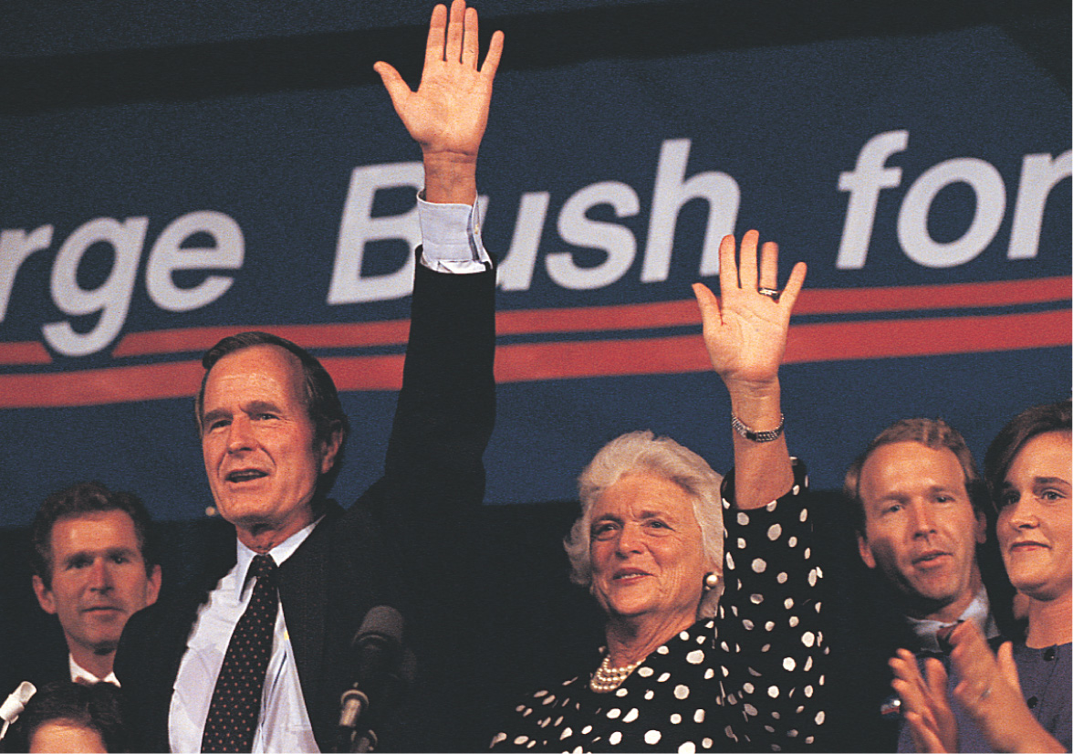 George Bush waves with his family.