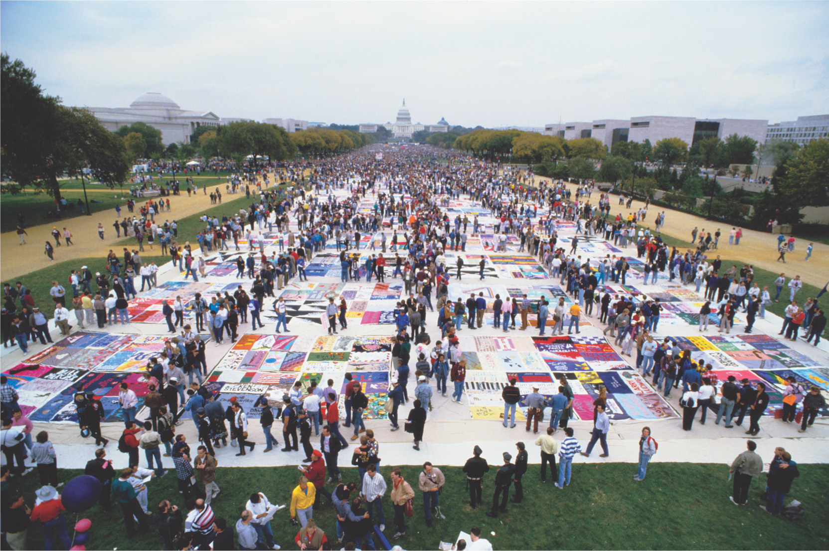 Photo: people walk on a huge quilt the size of several football fields.