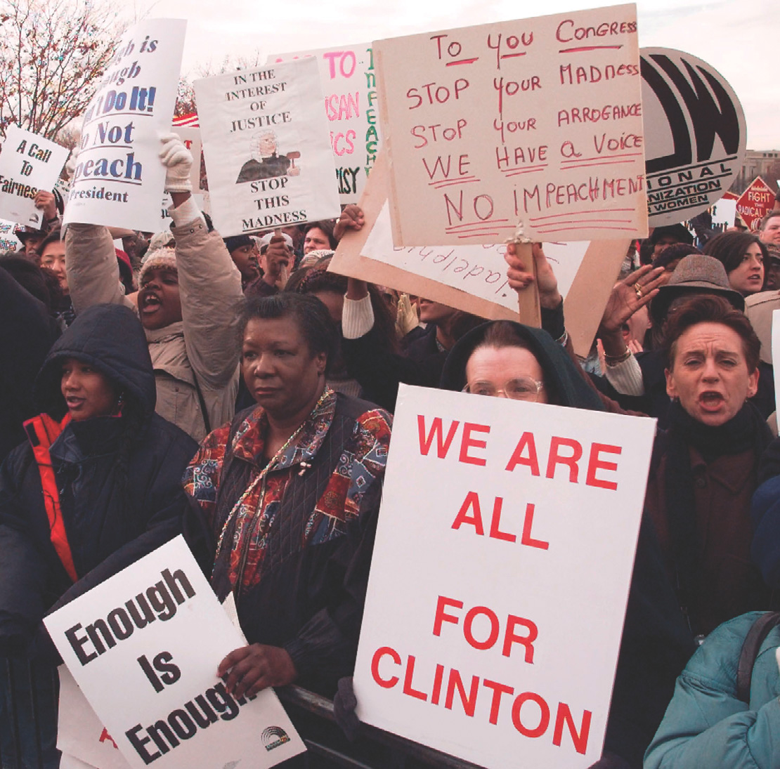 photo: protesters hold signs that read 'Enough is Enough' 'No Impeachment' and 'We are all for Clinton.'