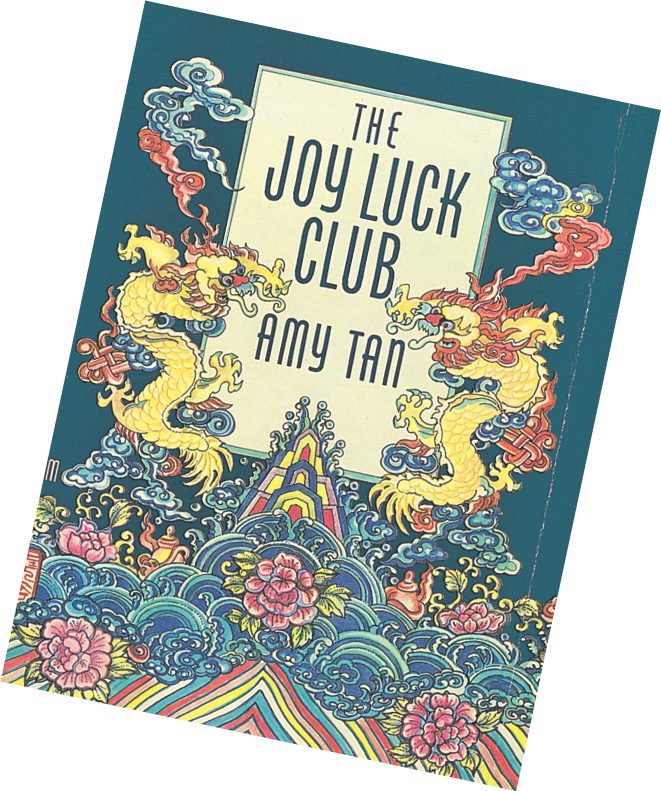 A book cover decorated with chinese dragons reads 'The Joy Luck Club' by Amy Tan.