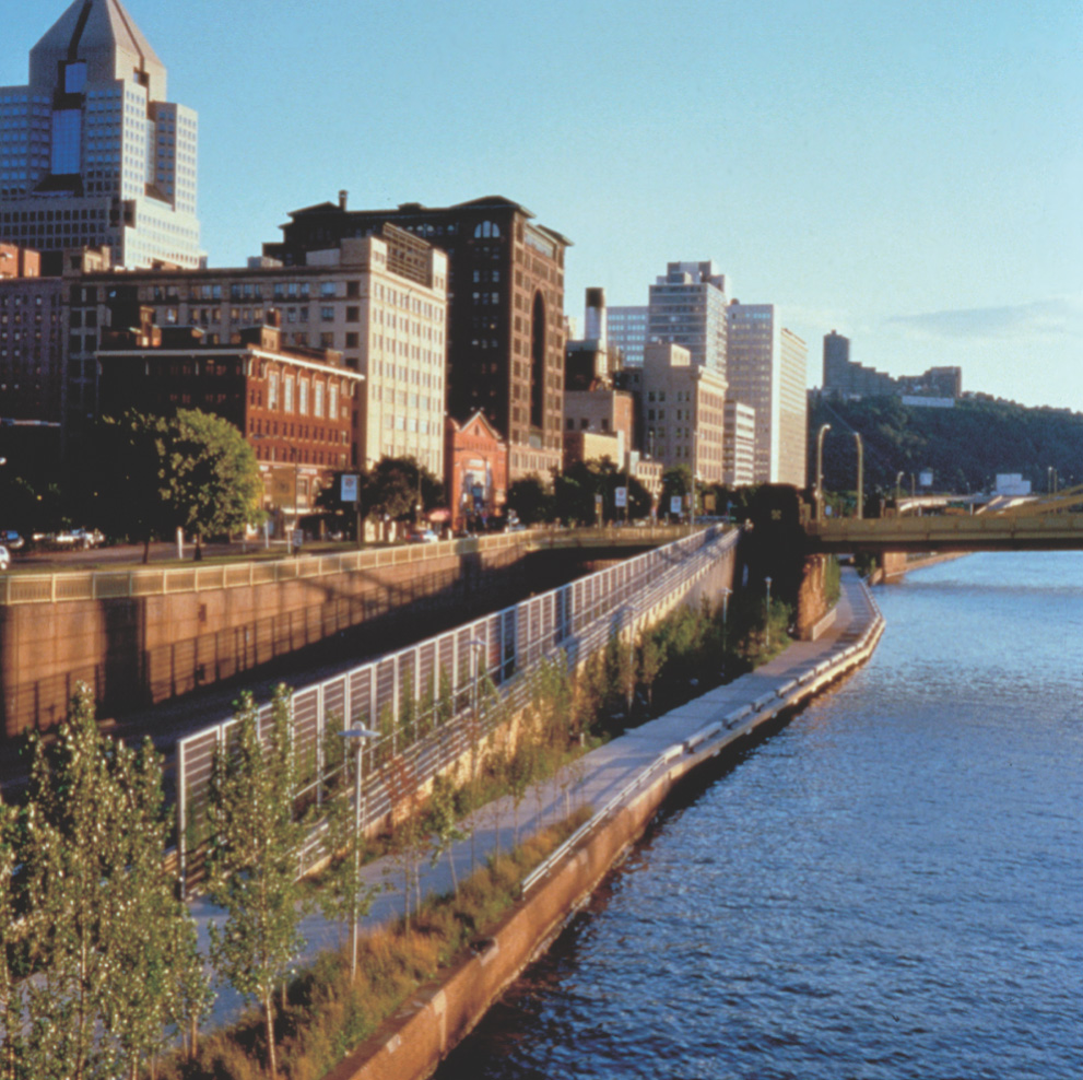 In a city, a walking path runs alongside the Allegheny River.