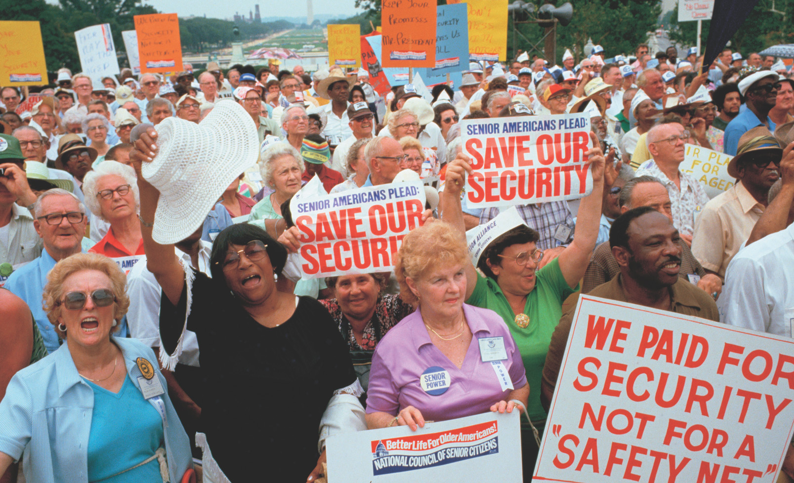 photo: elderly protesters carry signs that read 'Save Our Security' and 'We paid for security not for a Safety Net.'
