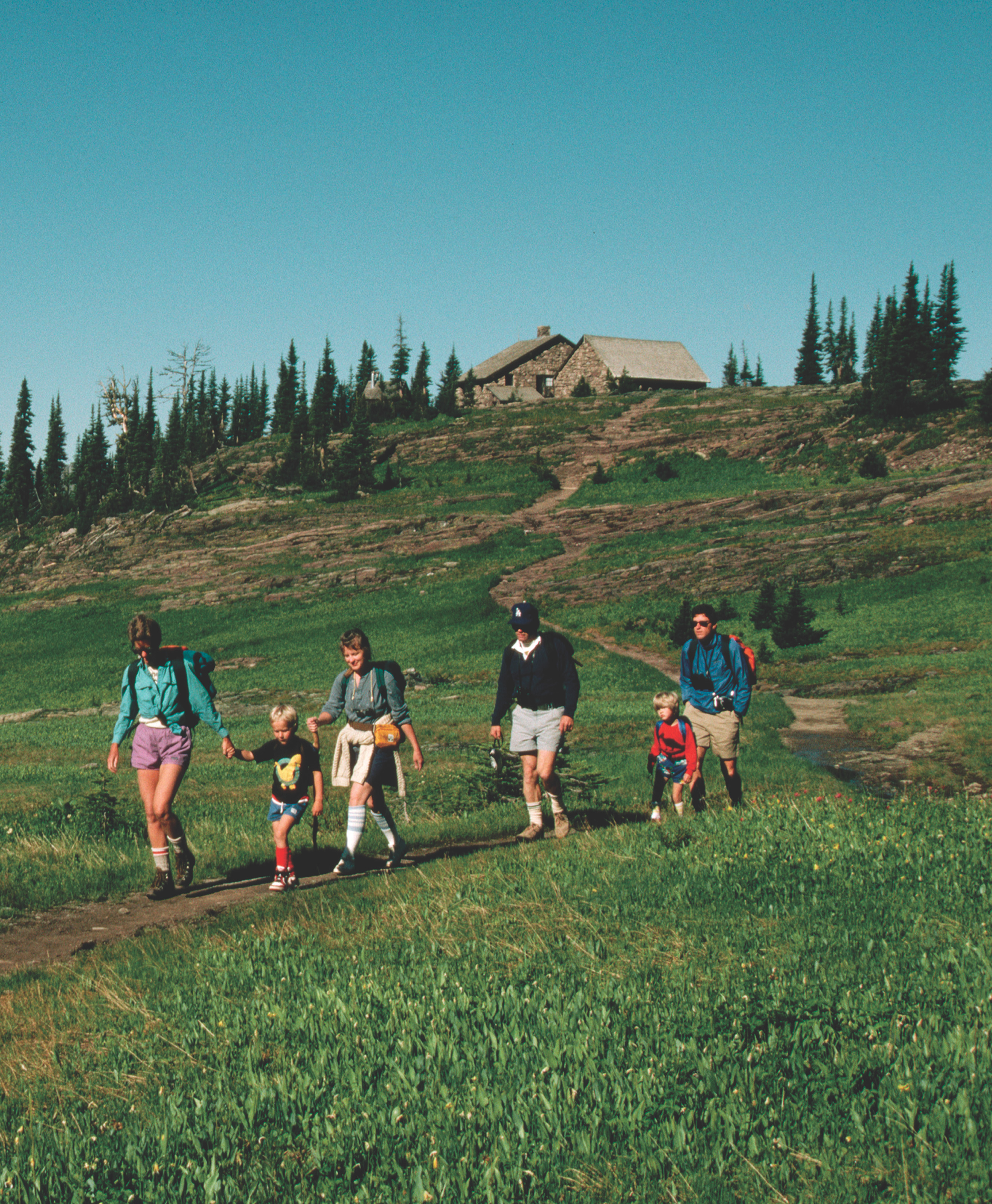 photo: A family hikes a mountain trail. A title: Issues for the 21st century.