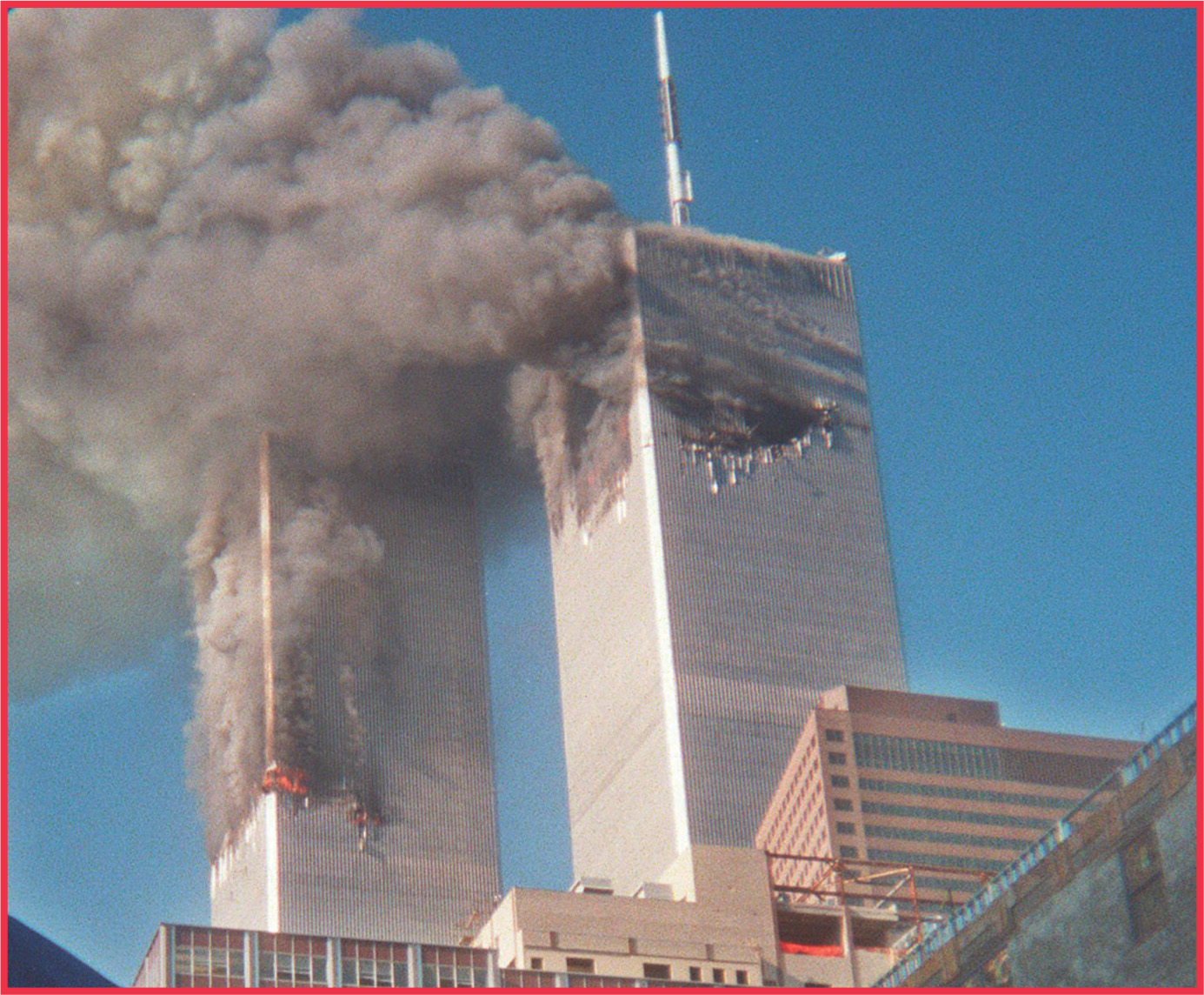 photo: smoke pours out of the damaged the World Trade Center towers.
