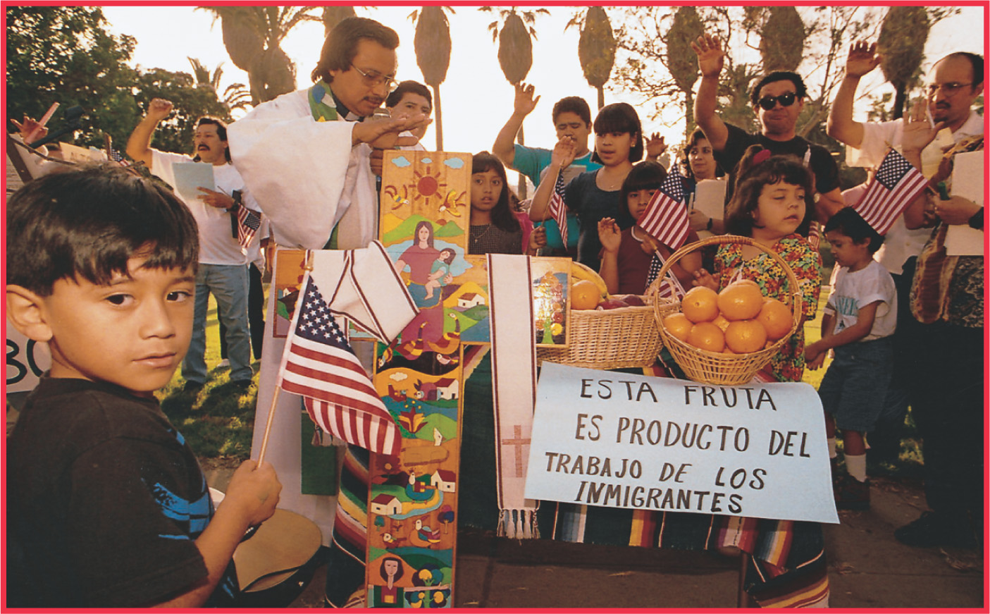 photo: Latino people hold American flags and signs in Spanish.