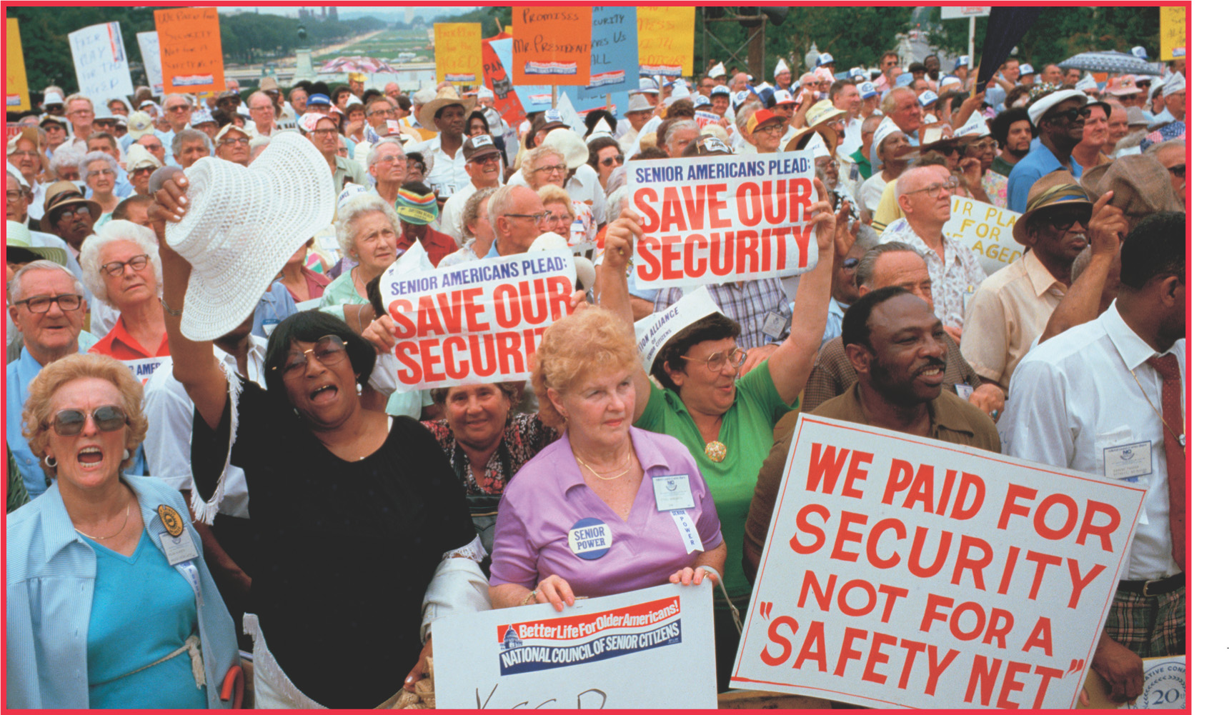 photo: elderly protesters carry signs that read 'Save Our Security' and 'We paid for security not for a Safety Net.'
