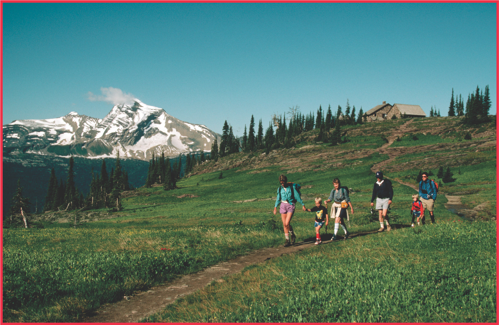 photo: a family hikes on a mountain trail.